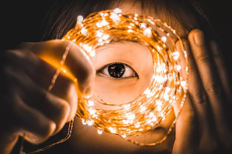 Young Girl Looking Through Led Lights